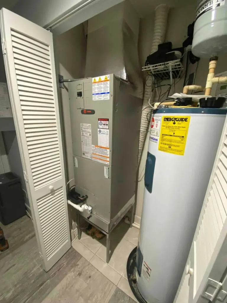 Tank water heater inside a closet.