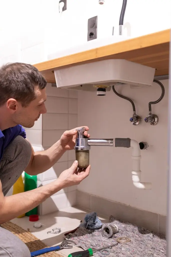 Plumber checking commercial pipes.