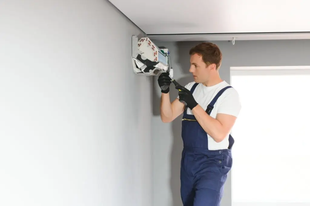 Technician finishing a mini split installation.
