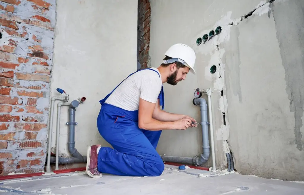 Plumber checking pipes after a repiping project.