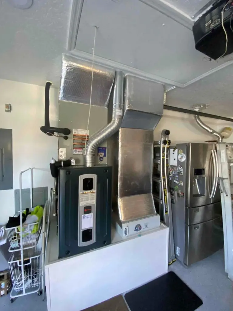 Furnace post-service in a utility room.