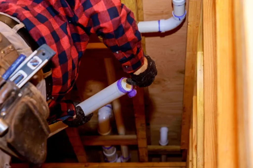 Plumber installing new pipes.