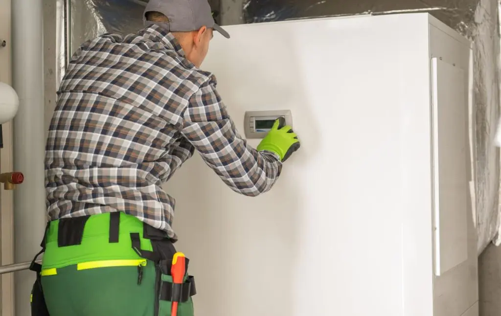Technician finishing a heat pump installation.