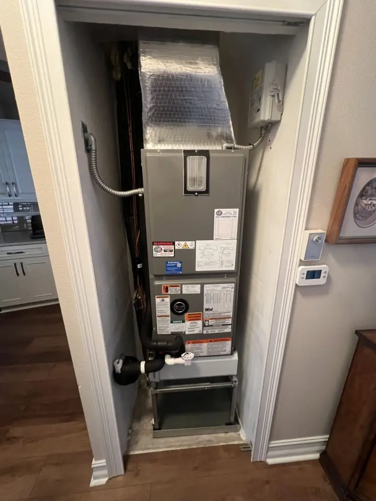 Recently repaired furnace inside a closet.