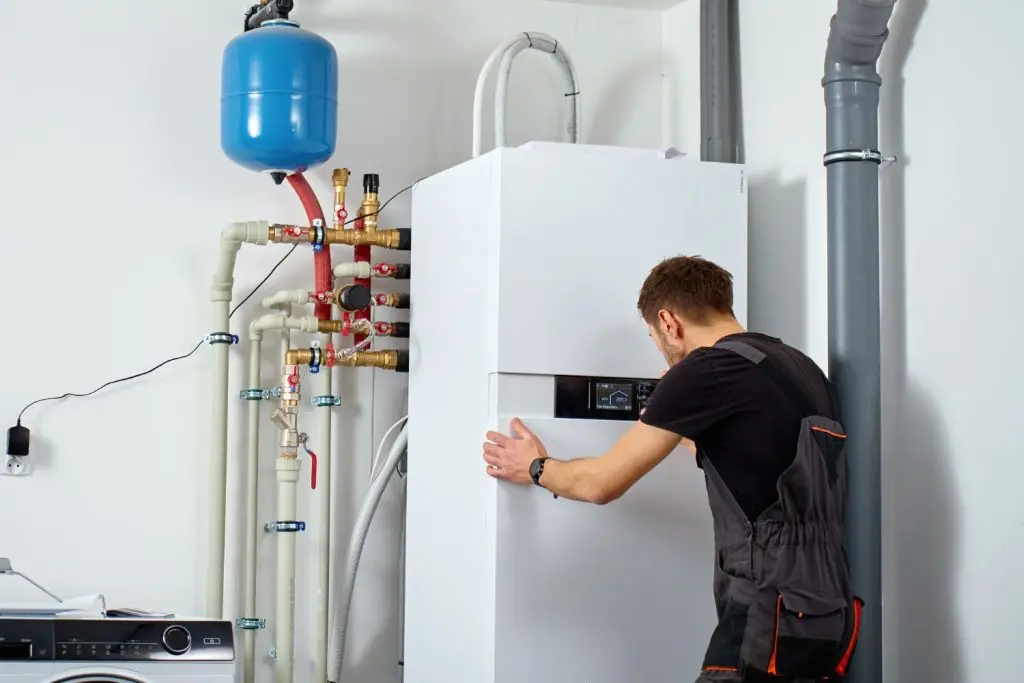Technician tuning a heat pump unit.
