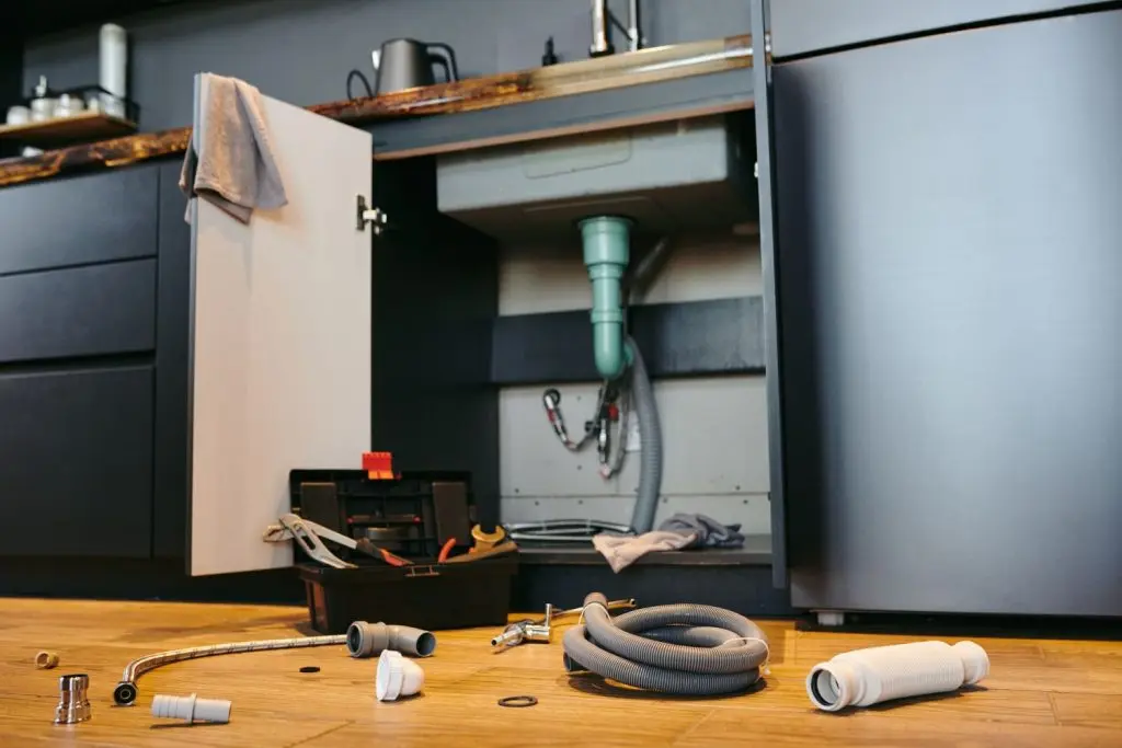 Pipes inside a cabinet with tools.